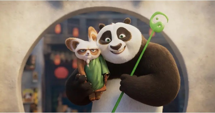 This is Kung Fu Panda 4 characters where Po is smiling by taking Master Shifu in his hand.